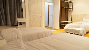A hotel room with two beds, a wardrobe, a mirror, and a hanging wardrobe. - Dakhla Roof Top (Dakhla)