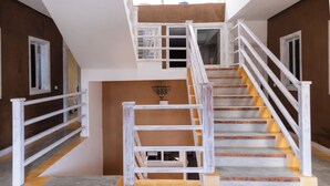 A staircase with white railings and wooden steps leading to an upper floor. - Dakhla Roof Top (Dakhla)