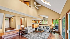 A spacious living area with a ceiling fan, a sofa set, a coffee table, and a rug. - Wanderlust •HotTub •Spa Room w/Sauna •2 King Suites (Gatlinburg)
