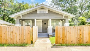 A single-story house with a front porch, a wooden fence, and a concrete pathway leading to the entrance. - Newly Renovated Birmingham Home: 7 Mi to Dtwn! (Birmingham)
