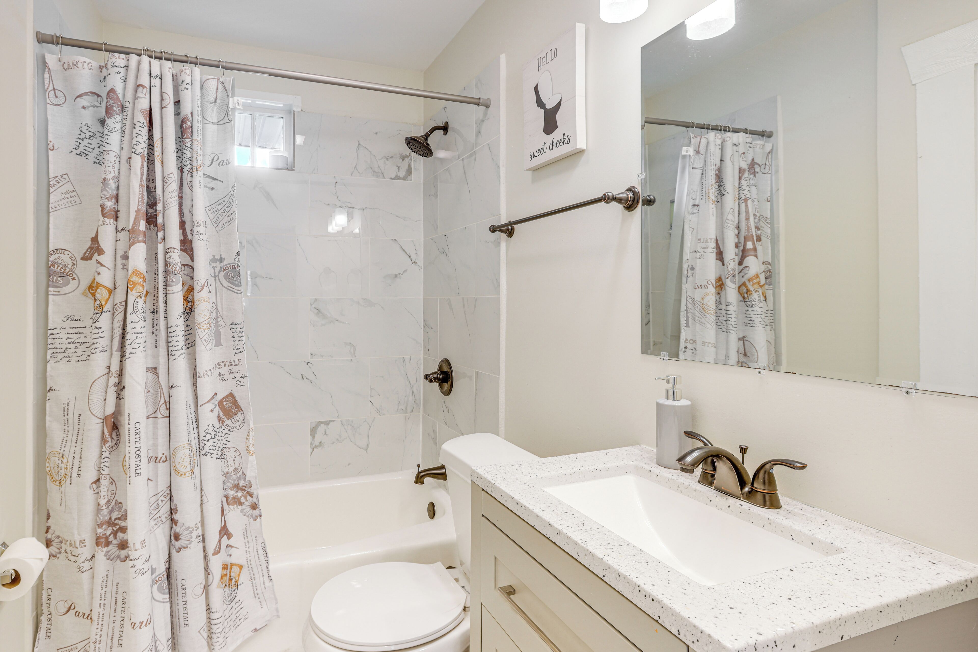 A bathroom with a bathtub, toilet, and sink.