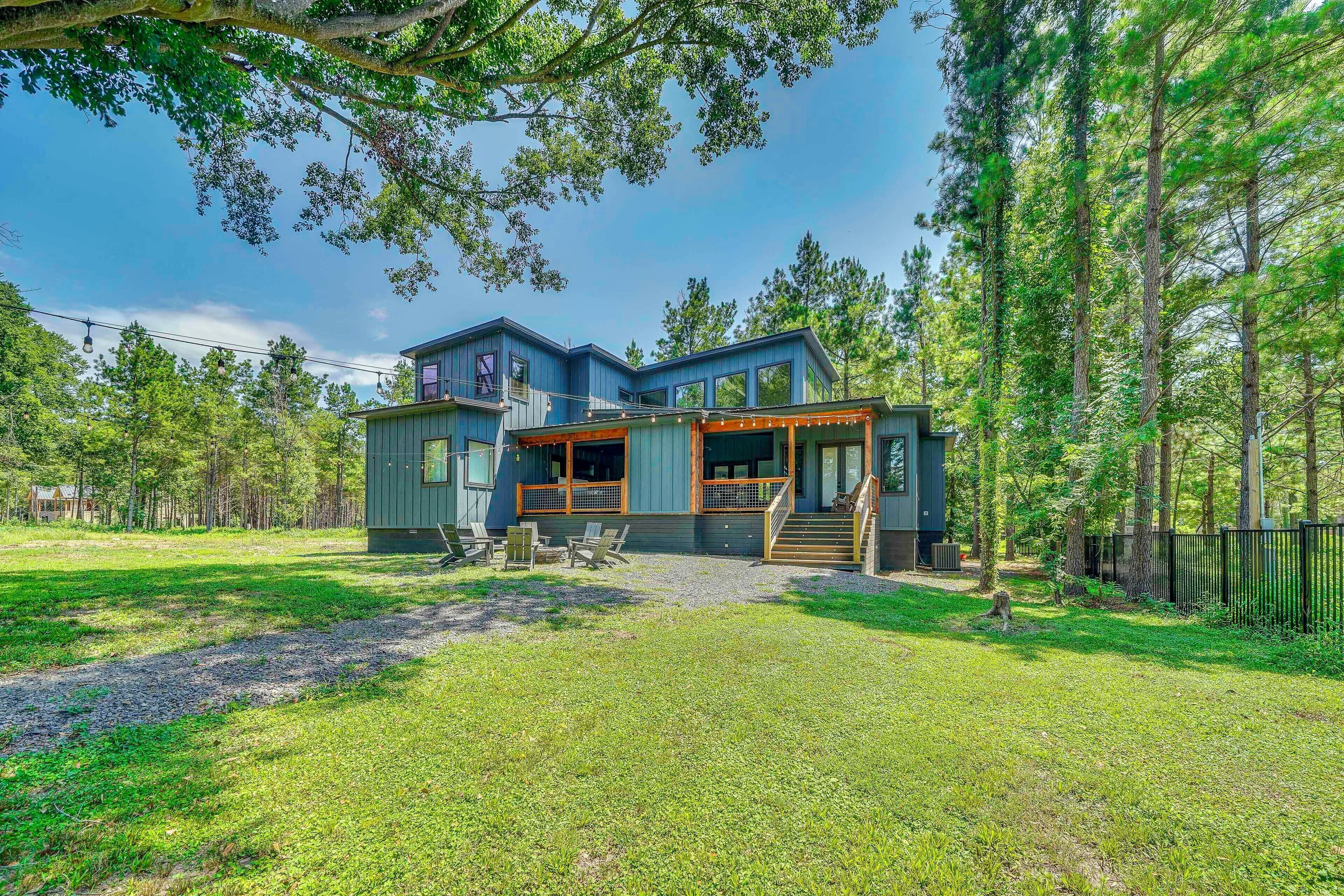 A two-story house with a covered porch and a small deck.