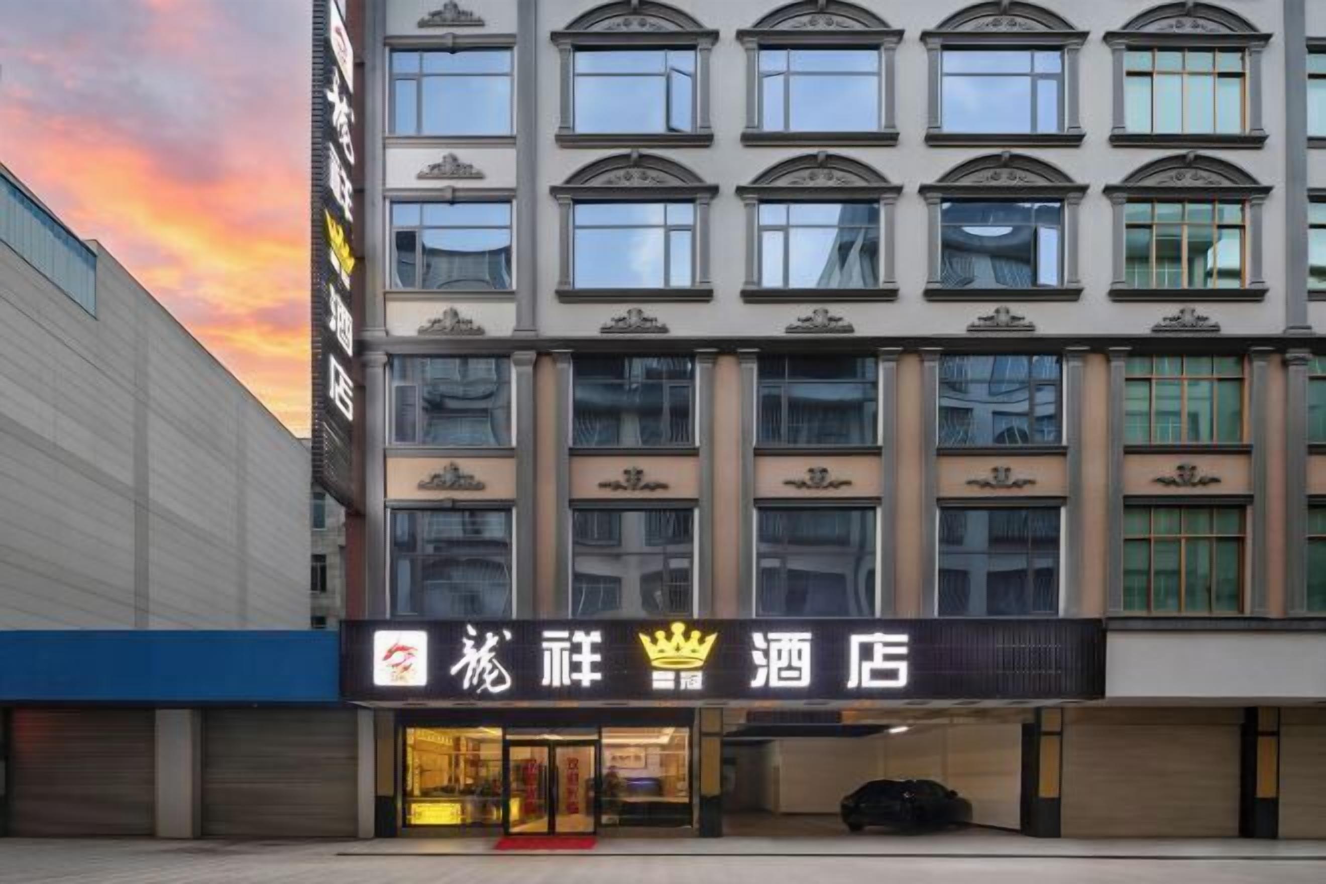 A hotel with a traditional facade, multiple windows, and a prominent entrance.
