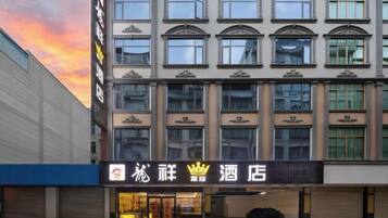 A hotel with a traditional facade, multiple windows, and a prominent entrance.