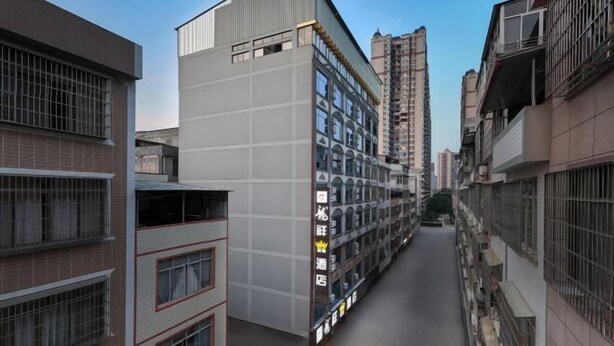 A narrow urban street flanked by multi-story buildings with balconies and windows.