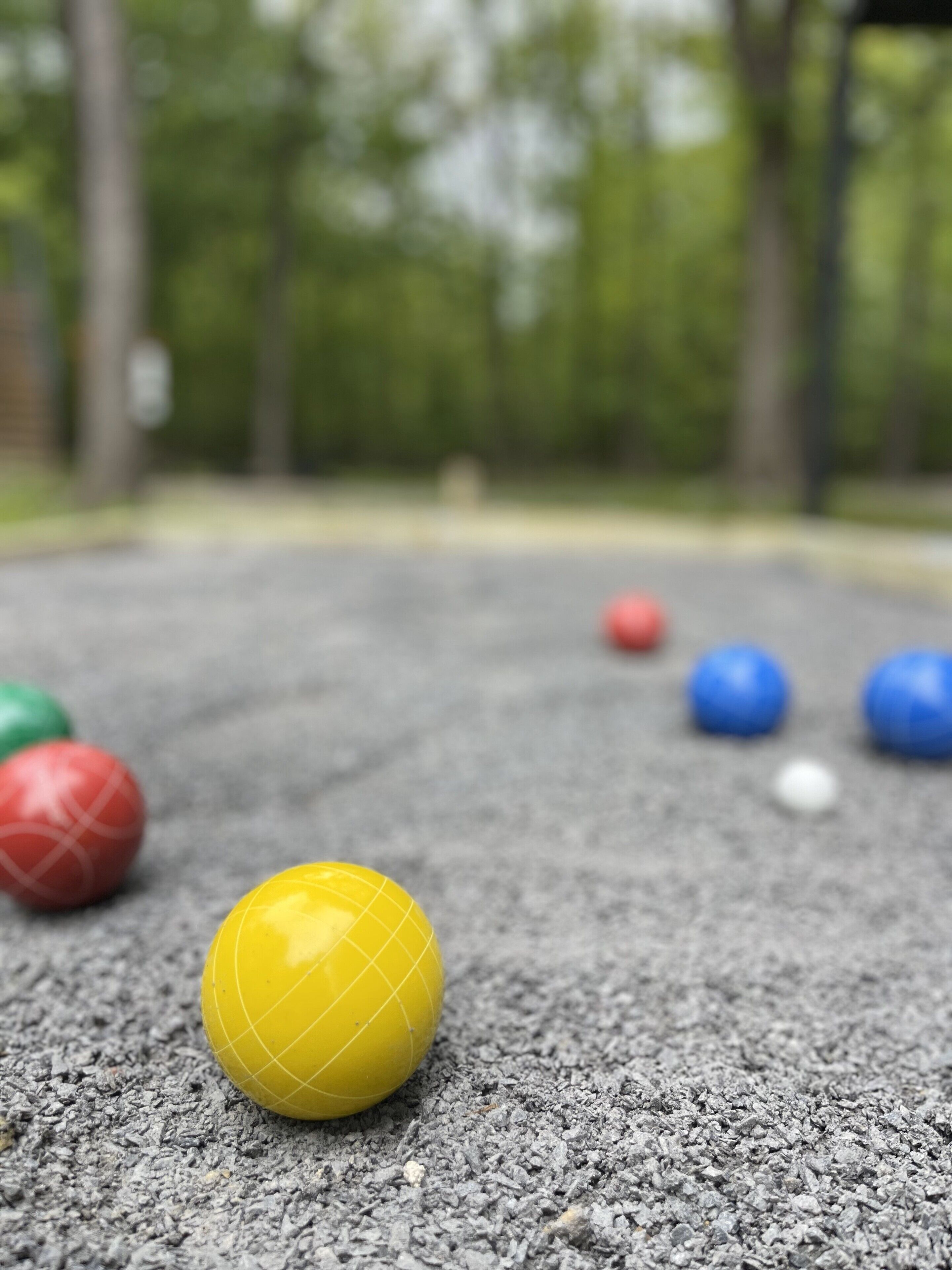 A close-up of colorful balls on a textured surface.