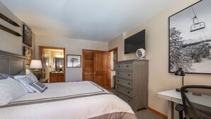 A bedroom with a bed, a desk, a chair, a dresser, and a TV. - Value Unit 1422 - 2br - Zephyr Mountain Lodge 2 Bedroom Condo (Winter Park)