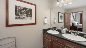 A bathroom with two sinks, a large mirror, and a framed photograph on the wall. - Value Unit 1422 - 2br - Zephyr Mountain Lodge 2 Bedroom Condo (Winter Park)