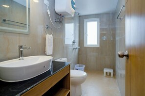 A modern bathroom with a large sink, toilet, and shower area. - Hotel Finger lime (Gangtok)