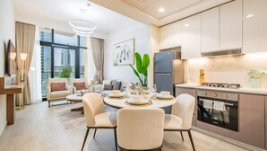 A modern kitchen with a built-in oven, a refrigerator, and a gas stove. - Inviting 2BR Apartment in Azizi Riviera 39, Al Merkadh by Deluxe Holiday Homes (Dubai)