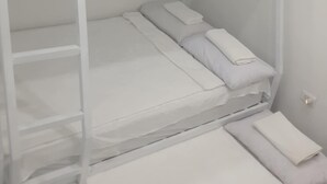 A bunk bed with a ladder, a lower bunk, and a single bed. - New Furn 1 Br/1 Bath/Kitchen, Manila-Univ Belt, AC, Hot water, Wifi, Netflix -u1 (Manila)