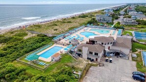 A resort with multiple swimming pools, a beach, and ocean views. - Sun Realty gorgeous pet-friendly oceanside home w/ pool, hot tub, & elevator! (Corolla)