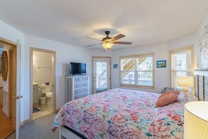 Relax in this cozy bedroom with a comfortable bed, dresser, and television.