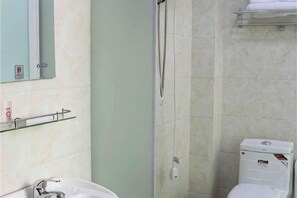 A bathroom with a sink, mirror, shower, and toilet. - Hefei Ruyi Inn (Hefei)