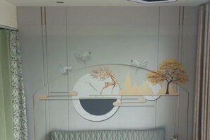 A wall with a circular design, a tree, and a cityscape silhouette. - Hefei Ruyi Inn (Hefei)