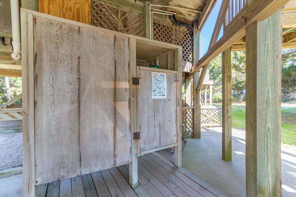 Une structure en bois avec une porte et une affiche accrochée au mur.