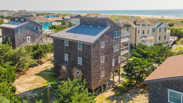 A coastal residential area with houses featuring a mix of modern and traditional architecture, some with visible balconies and others with flat roofs. - Semi Oceanfront home in Avon w/ ocean views (Avon)