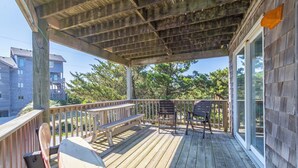A wooden deck with a bench, a chair, and a table. - Semi Oceanfront home in Avon w/ ocean views (Avon)