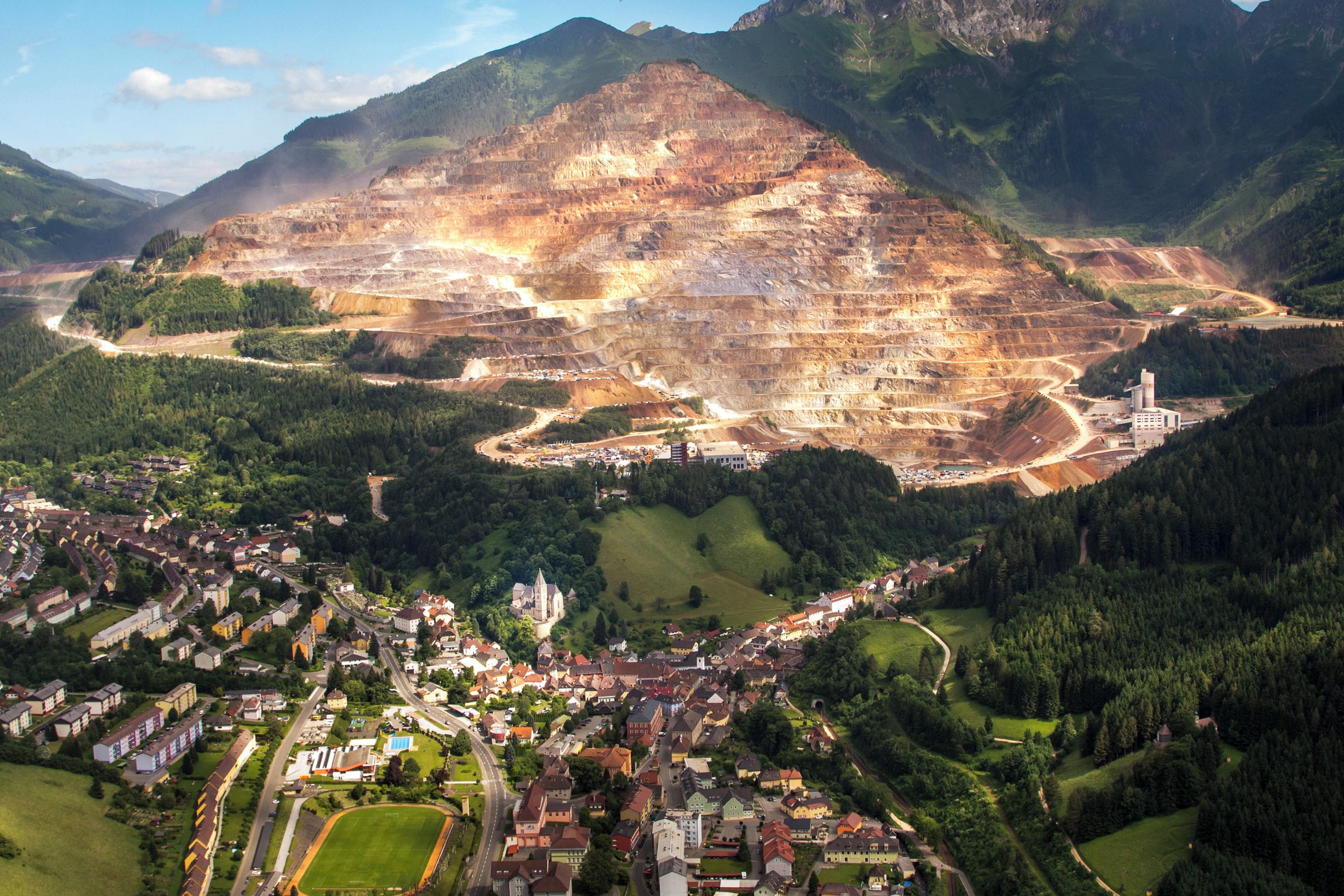 A mountainous landscape with a large open quarry.