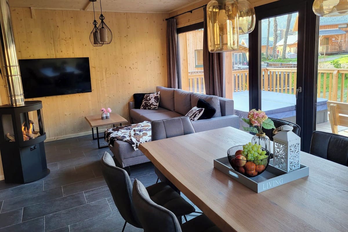 Una sala de estar acogedora con un sofá, una mesa de comedor con fruteros y una chimenea.