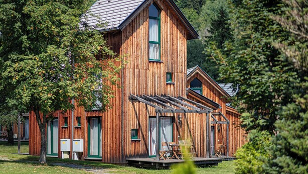 A wooden cabin with a large porch, multiple windows, and a sloped roof. - Ferienpark Kreischberg (Sankt Georgen am Kreischberg)
