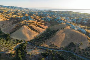 A rugged landscape with rolling hills and a winding road.