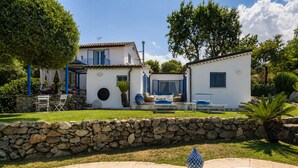 A two-story house with a stone wall, a swimming pool, and outdoor furniture. - Villa Acquaro Santa Caterina  (Santa Caterina dello Ionio)