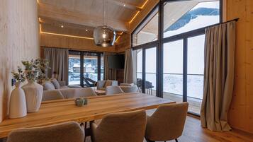 A spacious room with a large wooden table, several chairs, and a television.