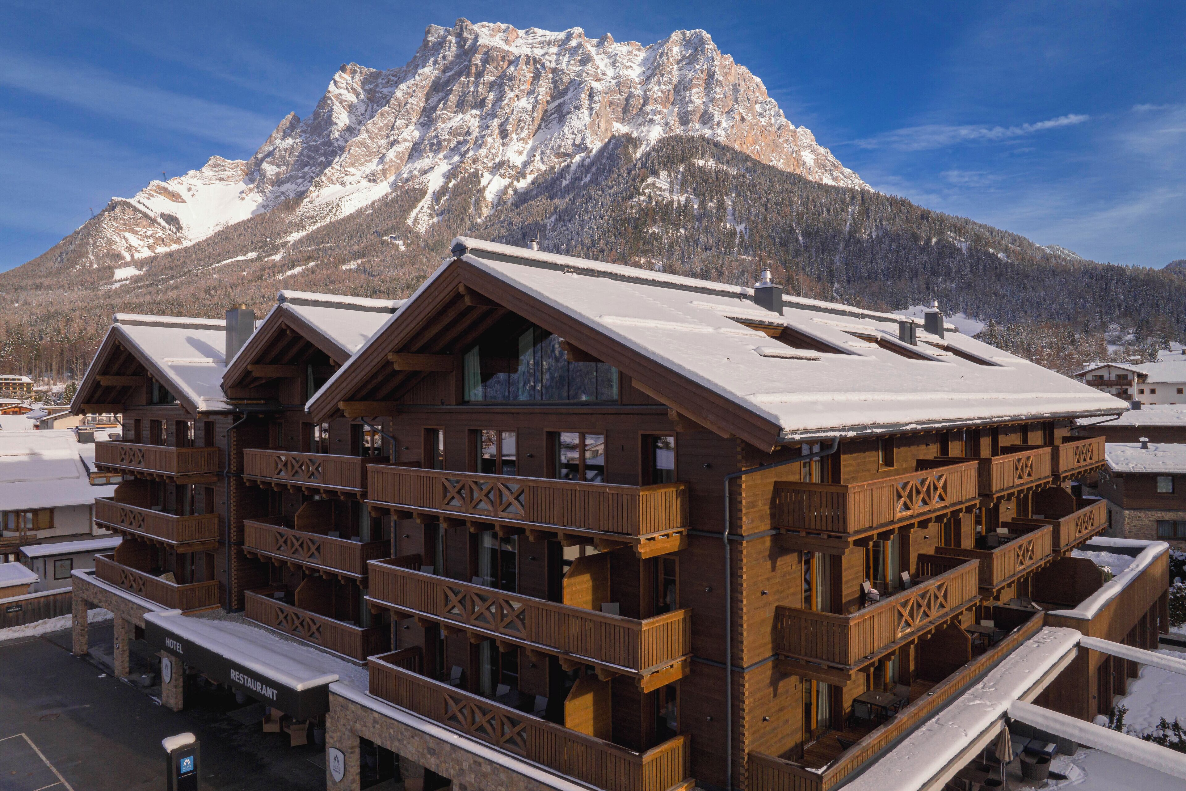 A multi-story wooden building with balconies, a restaurant, and a hotel.
