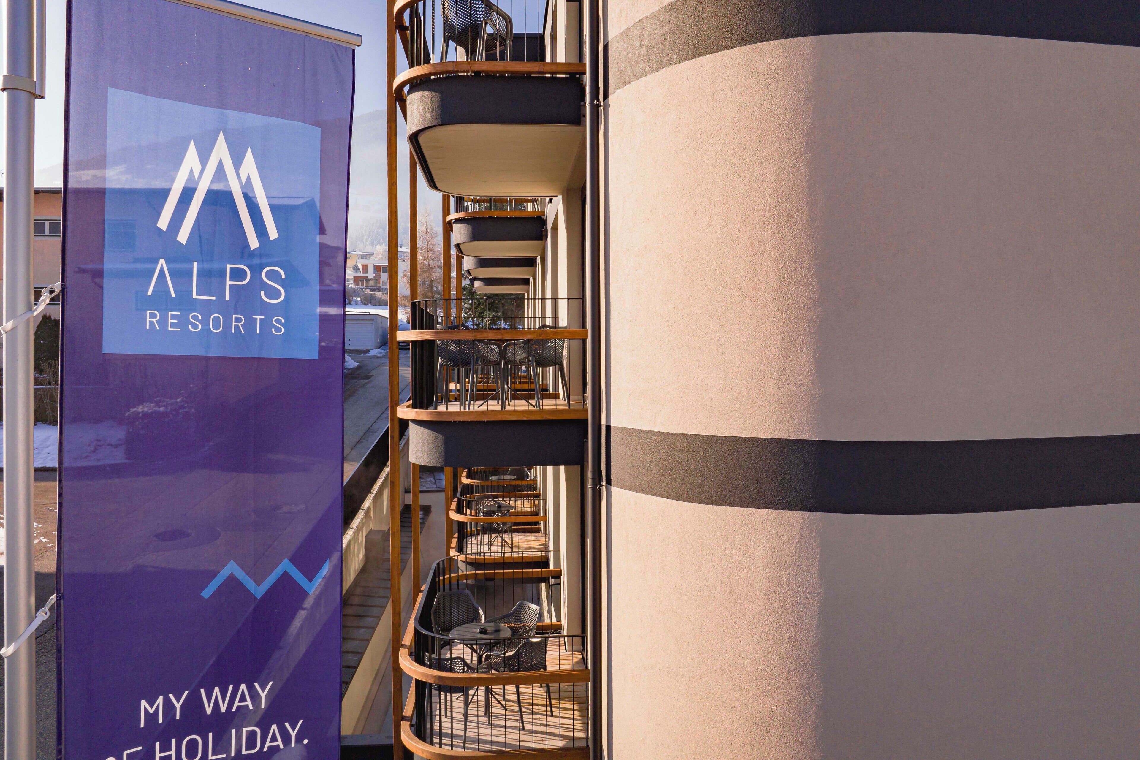 A vertical banner with the text "ALPS RESORTS" and "MY WAY OF HOLIDAY."