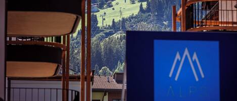 A view of a mountain resort with a sign for ALPS RESORTS Suites.