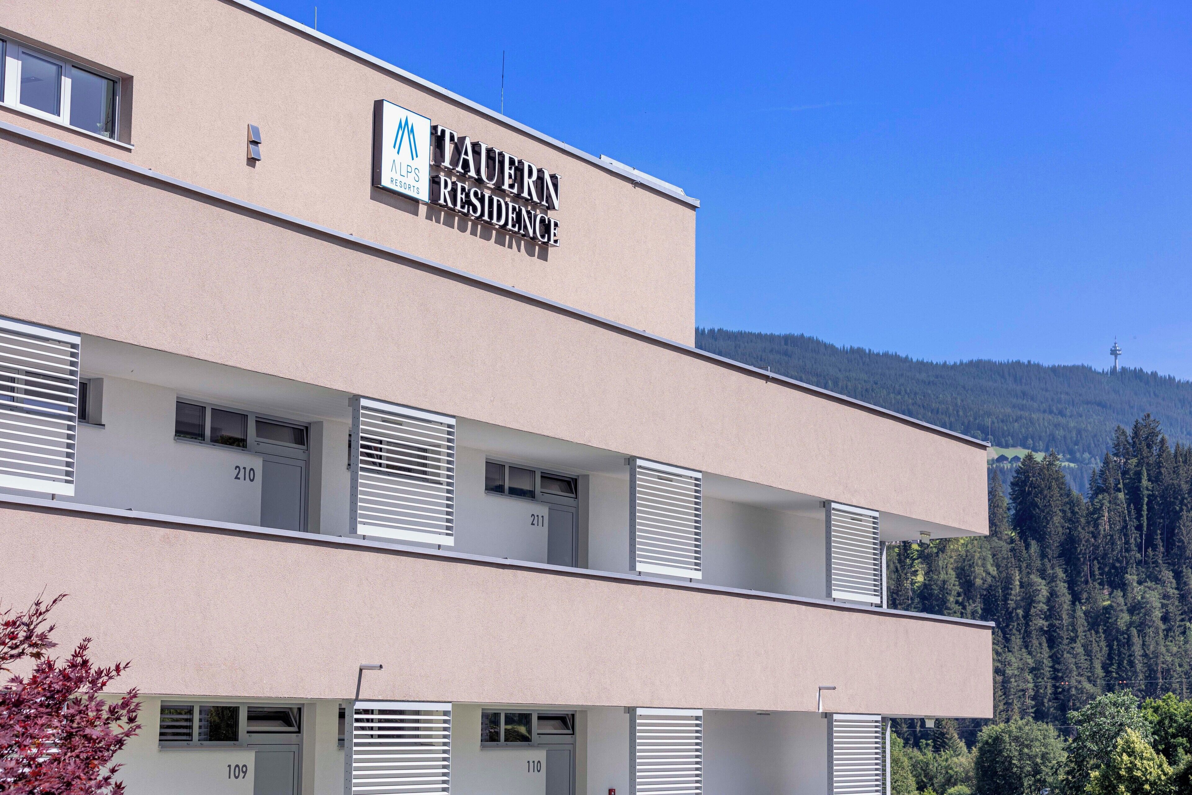 A multi-story building with a sign reading "Tavern Residence."