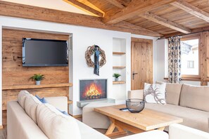 Relax in style with a comfortable sofa, flat-screen TV, and cozy fireplace.