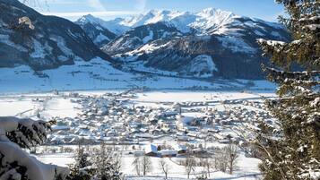 A snow-covered town with mountains in the background.