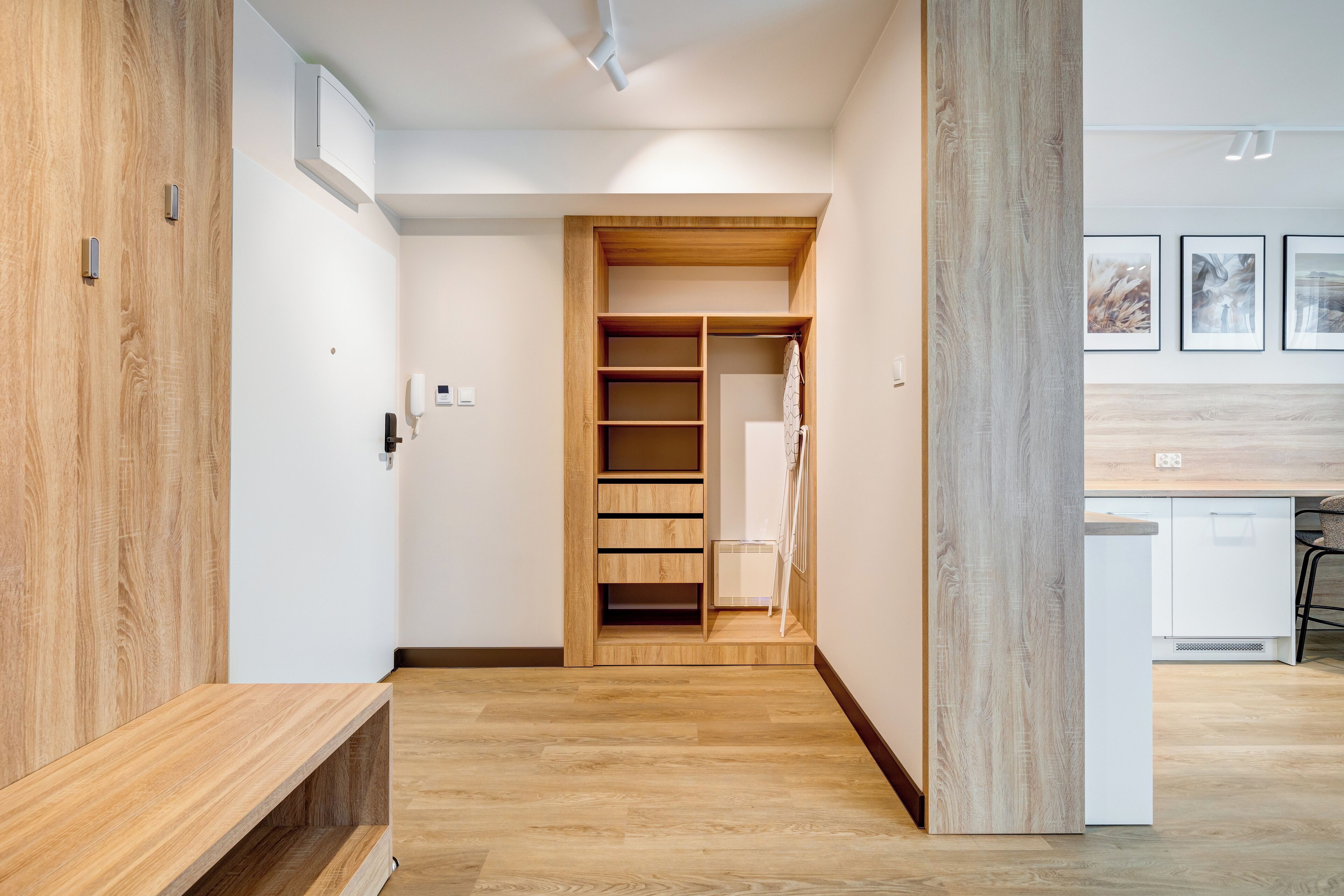 Una cucina moderna con mobili bianchi e un piano di lavoro in legno.