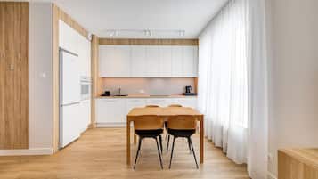 Deluxe Condo, Balcony, City View | Living area | 55-inch flat-screen TV with cable channels