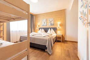 A wooden bunk bed room with a bed, two wall-mounted lamps, and a wooden headboard. - Naturpark Chalets Lambrecht (Sankt Lambrecht)
