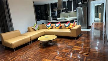 Superior Triple Room | Living room | Flat-screen TV