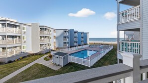 A residential building with a swimming pool, balconies, and a view of the beach. - A Place at the Beach III 9520-2B Summer Escape at Myrtle Beach Ocean View Condo (Myrtle Beach)