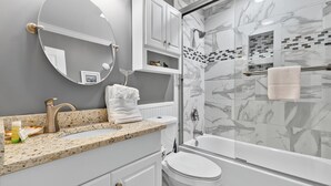 A bathroom with a granite countertop, a white toilet, a glass-enclosed shower, and a white vanity. - A Place at the Beach III 9520-2B Summer Escape at Myrtle Beach Ocean View Condo (Myrtle Beach)