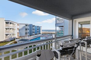 A balcony with a pool, white railings, and a view of the ocean. - A Place at the Beach III 9520-2B Summer Escape at Myrtle Beach Ocean View Condo (Myrtle Beach)