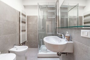 Een douche, een haardroger, een bidet, handdoeken