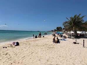 Enjoy a serene beach experience with calm waters and scenic views.