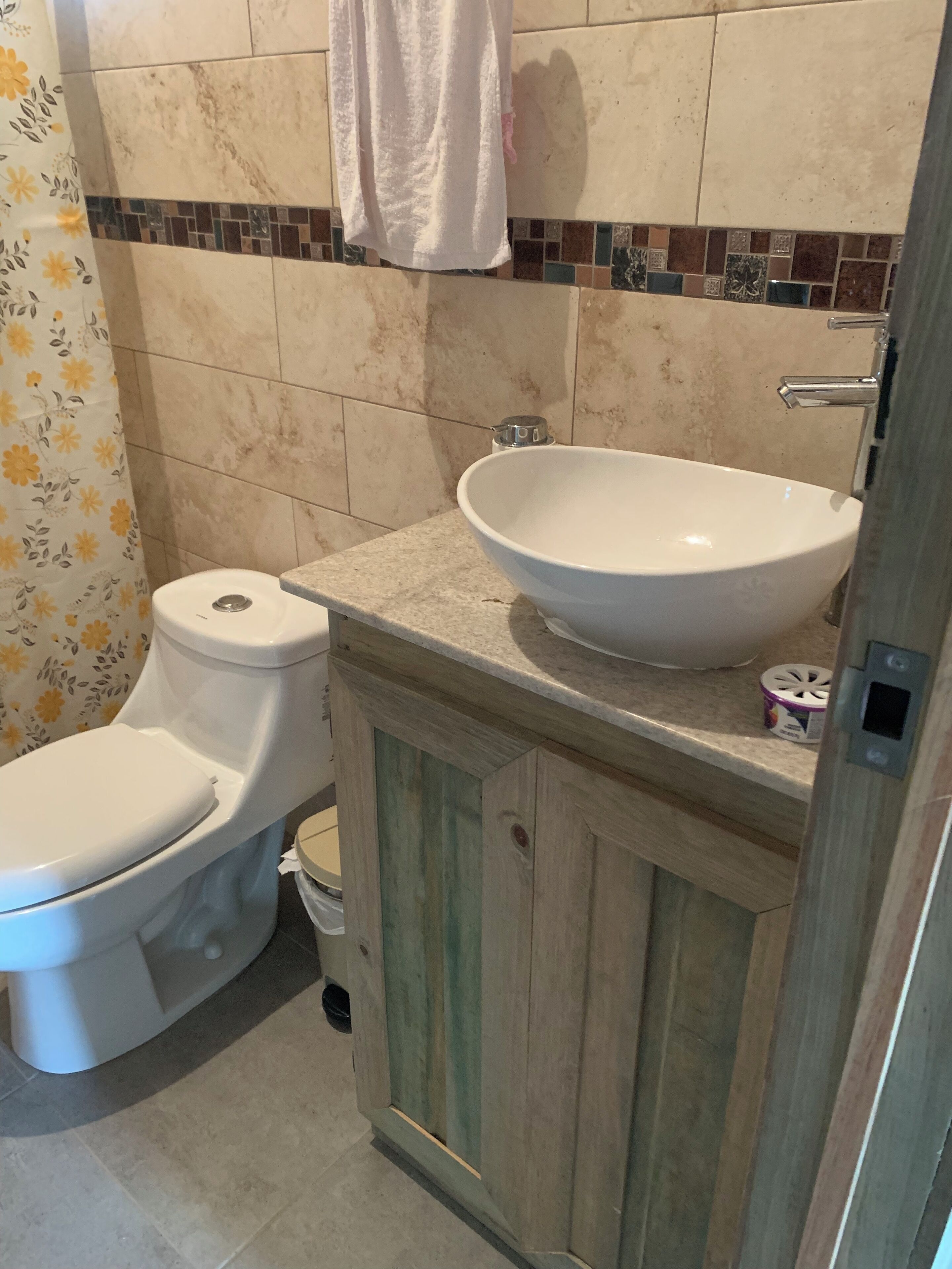 A bathroom with a toilet, a sink, and a shower.