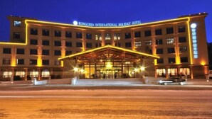 The Rongchen International Holiday Hotel with a prominent entrance and multiple floors. - Rongchen International Holiday Hotel (Zhangjiakou)