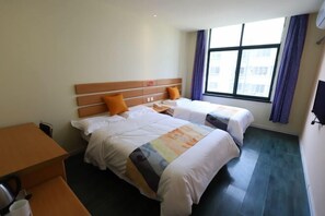 A hotel room with two beds, a desk, and a window with curtains. - Shell Hotel (Chengyang Agricultural University Subway Station) (Qingdao)