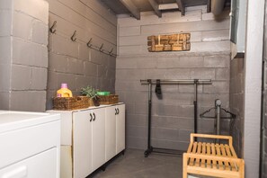 Functional space with a cabinet, hooks, and a bench for storage and seating.
