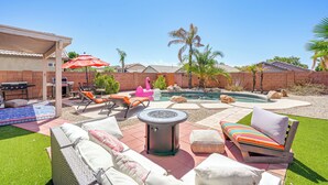 A backyard with a pool, outdoor furniture, and a pergola. - Outdoor Oasis! Family-Friendly North Phoenix Home (Phoenix)