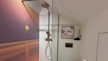 Een douche, een haardroger, handdoeken, toiletpapier