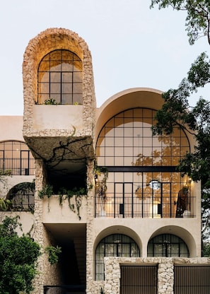 A building with a unique architectural design featuring arched windows and stone walls.